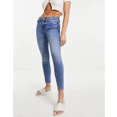 River Island Polyester Bukser & Shorts River Island Skinny-jeans med mellemhøj talje mellemblå vask DENIM